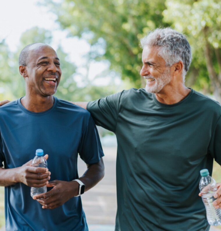 Two men laughing together on a walk